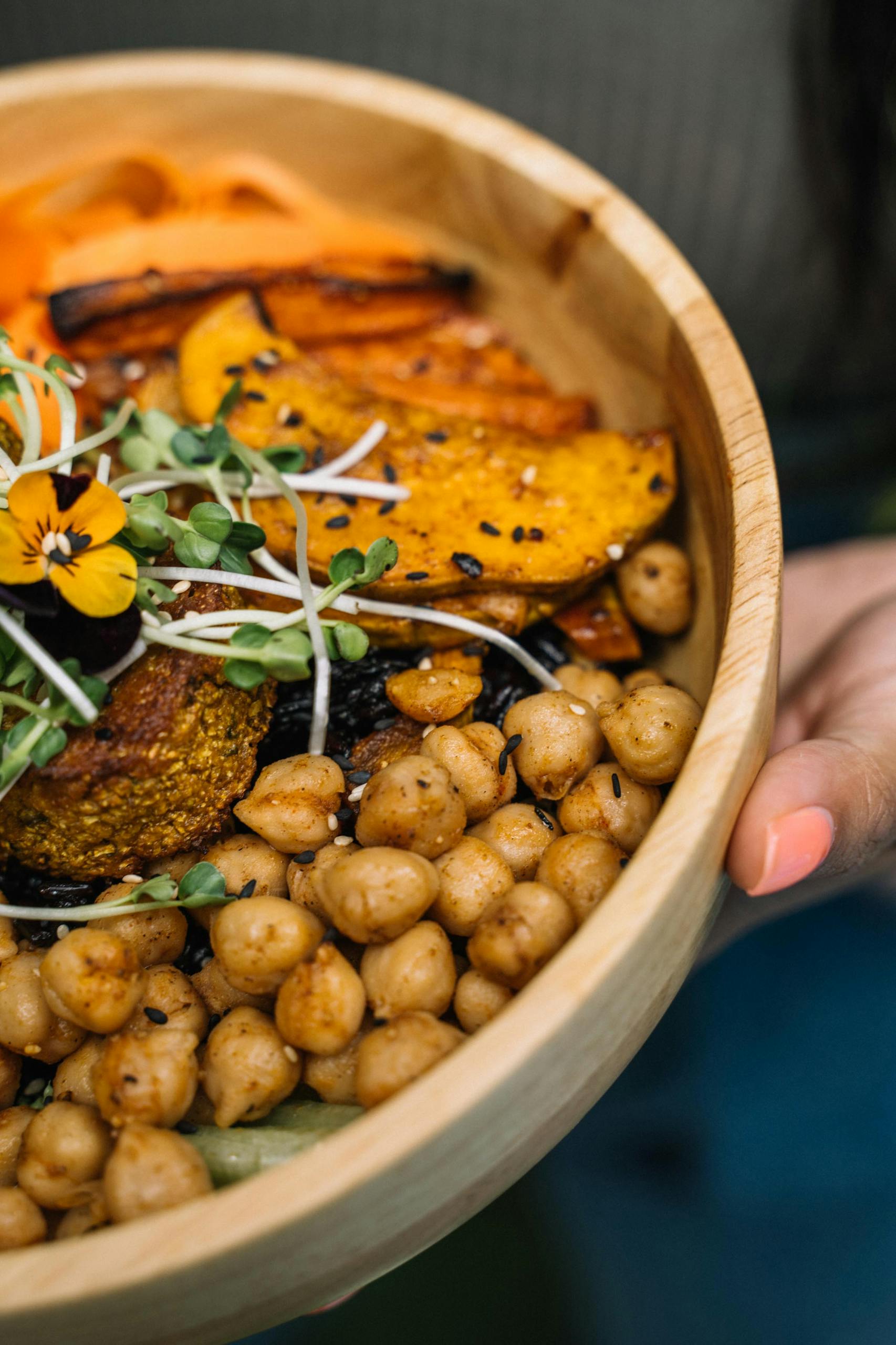 Delicious vegan Buddha bowl with chickpeas, squash, and greens, perfect for a healthy meal.