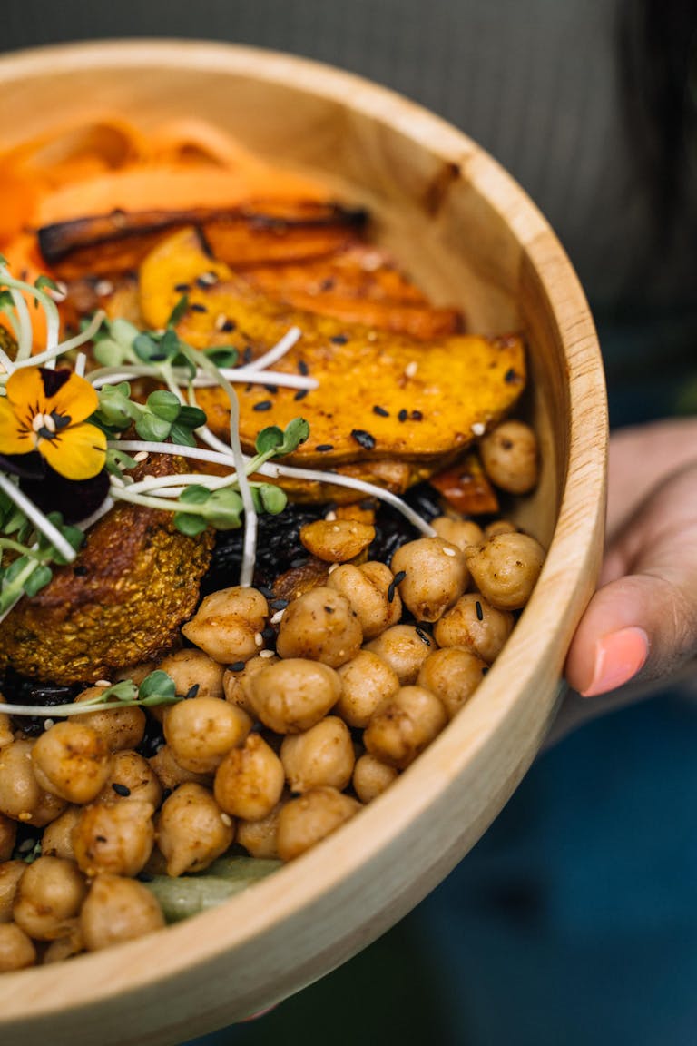 Delicious vegan Buddha bowl with chickpeas, squash, and greens, perfect for a healthy meal.